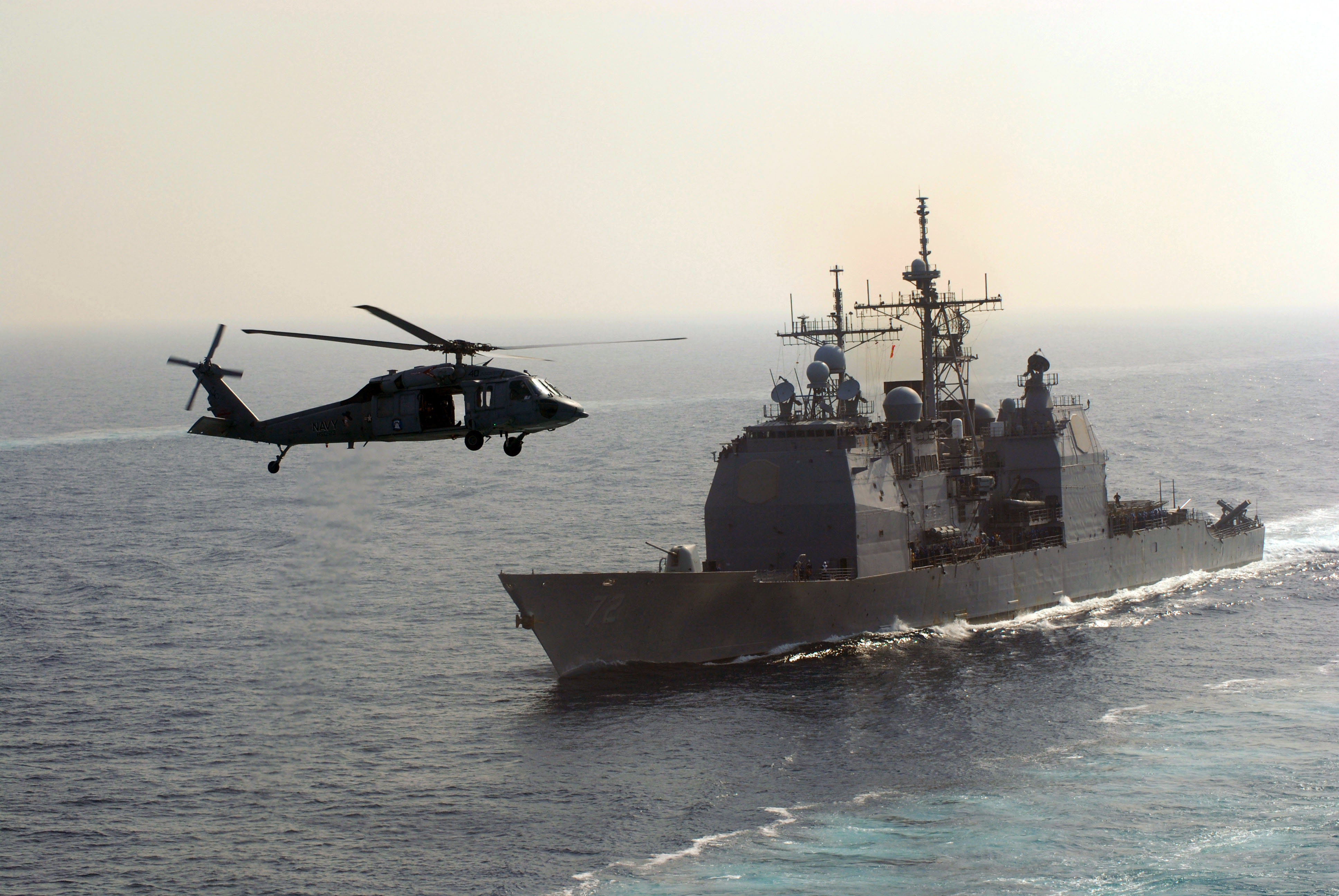 US Navy 070414-N-3038W-327 An MH-60S Seahawk, from the Predators of Helicopter Sea Combat Squadron (HSC) 23, flies near USS Vella Gulf (CG 72) during a replenishment at sea 
