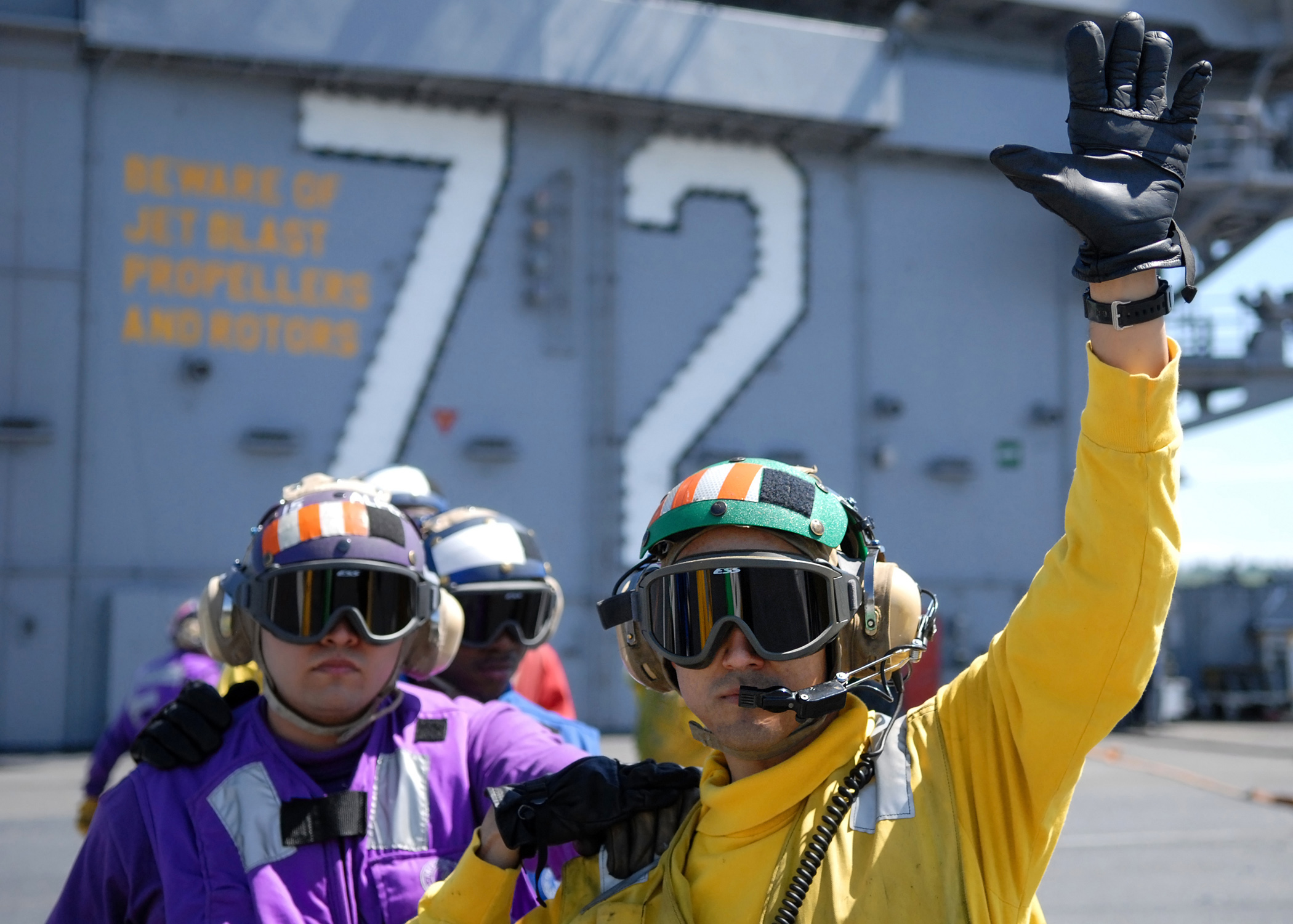 US Navy 070508-N-7981E-152 Flight deck personnel stand ready to fight a fire during a simulated crash scenario on the flight deck of Nimitz-class aircraft carrier USS Abraham Lincoln (CVN 72)