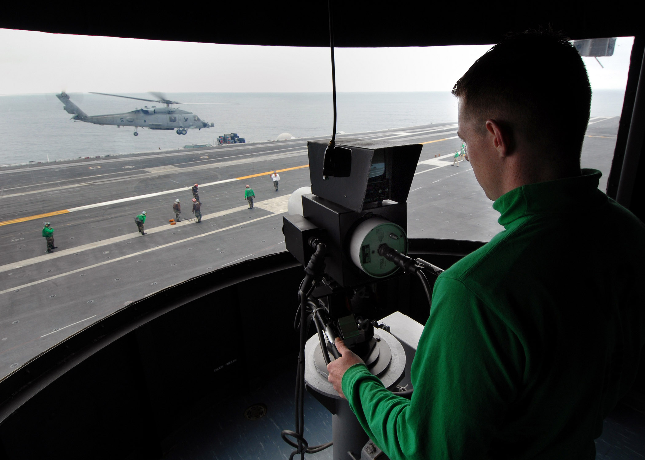 US Navy 070725-N-7981E-062 Electrician's Mate Fireman Preston Rucker, assigned to air department, operates the ship's Integrated Launch And Recovery Television Surveillance system during helicopter operations