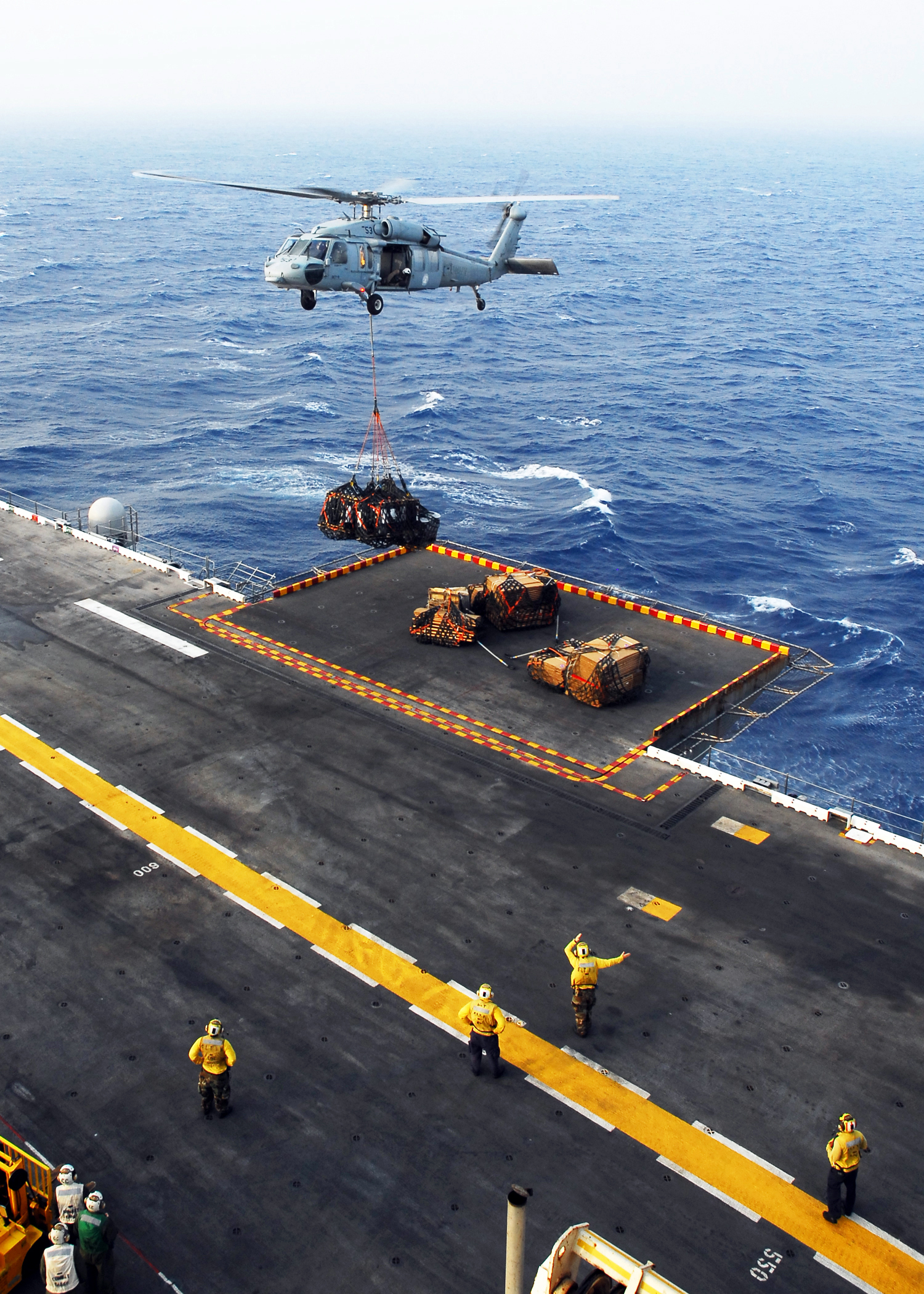 US Navy 080831-N-2183K-043 An MH-60S Sea Hawk helicopter delivers crates of supplies to the amphibious assault ship USS Peleliu (LHA 5) during a vertical replenishment at sea