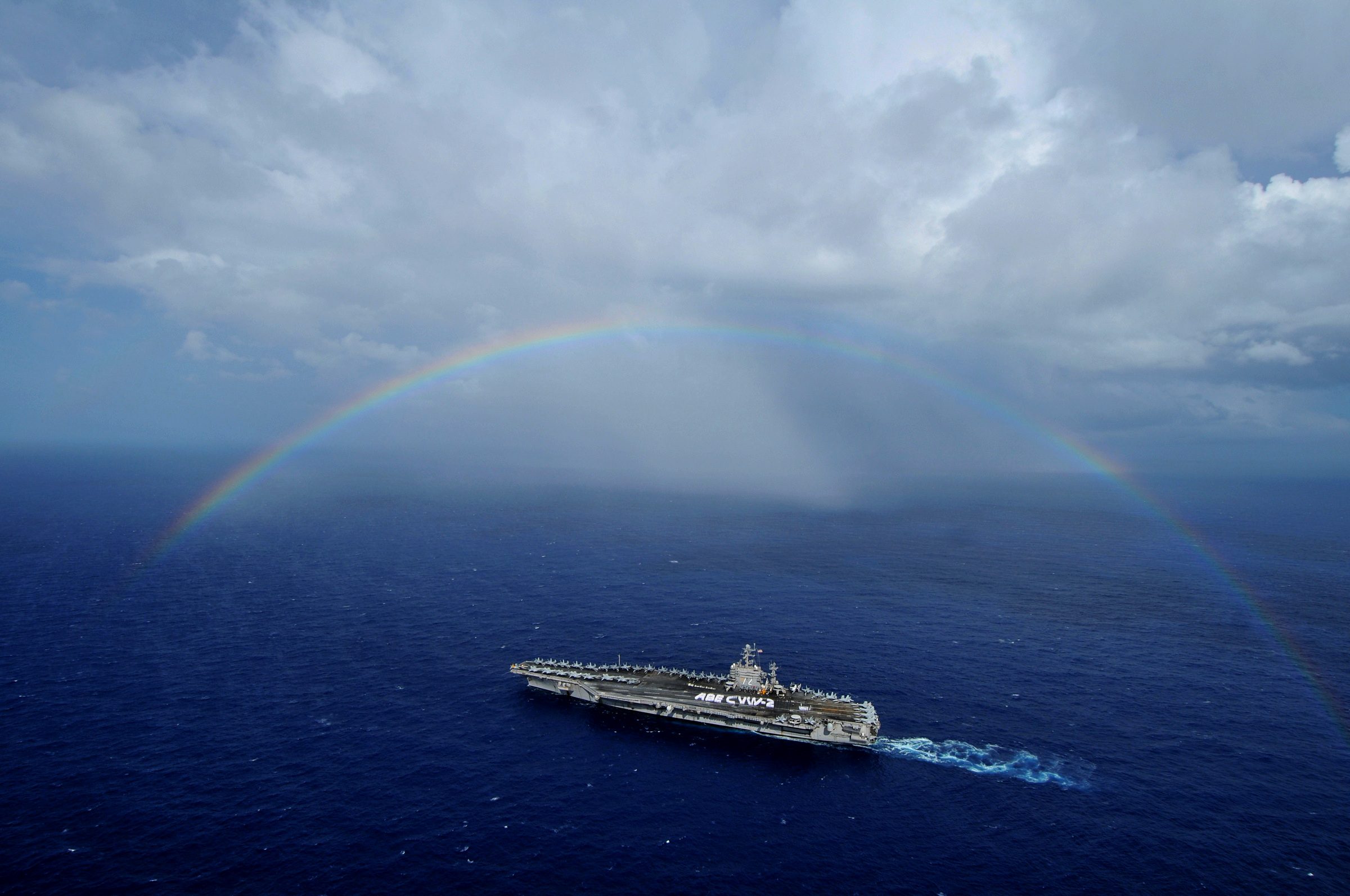 US Navy 080927-N-7981E-418 The aircraft carrier USS Abraham Lincoln (CVN 72) passes under a rainbow as Sailors from Lincoln and Carrier Air Wing (CVW) 2 participate in a 