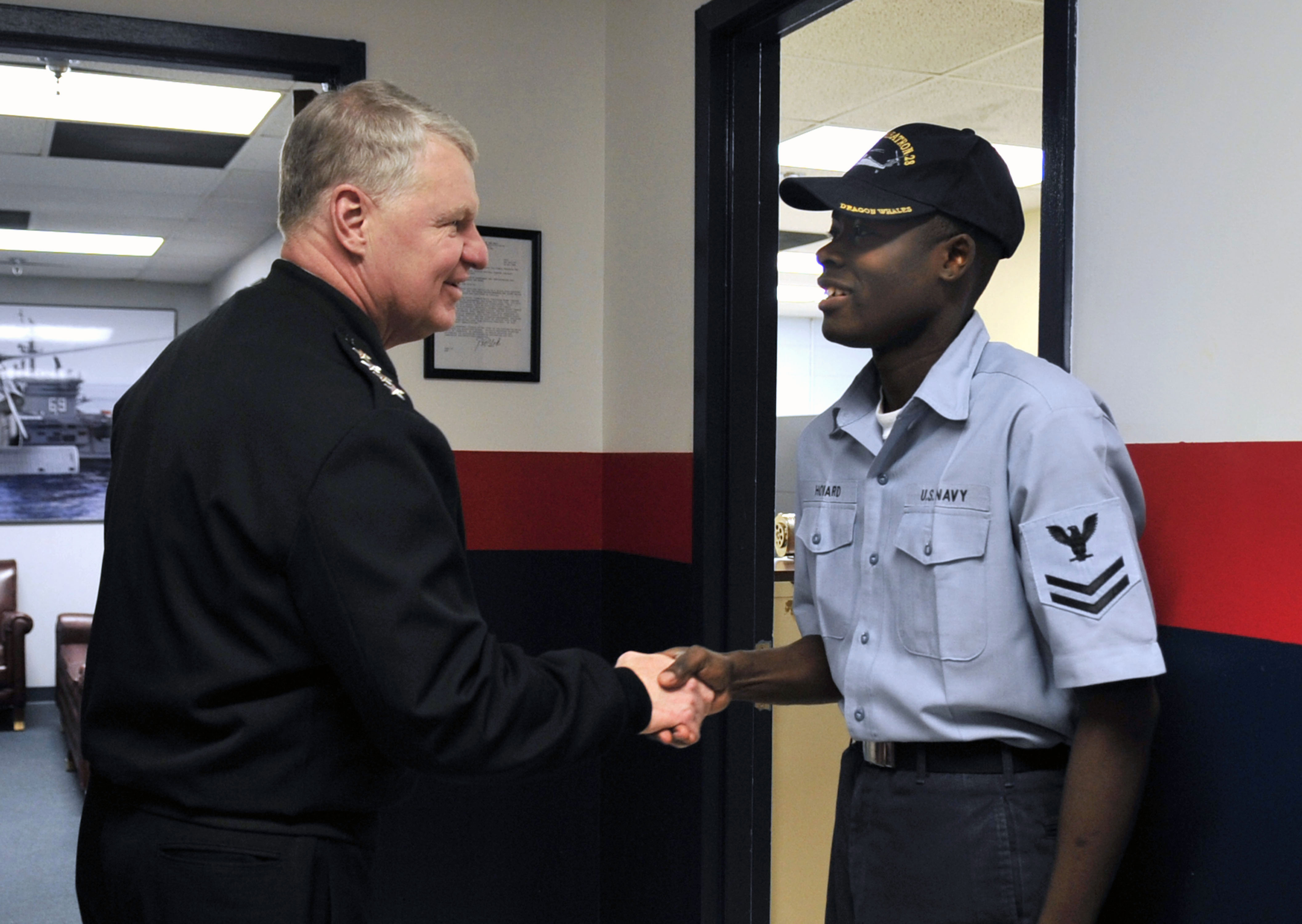 US Navy 090109-N-8273J-175 Chief of Naval Operations Adm. Gary Roughead congratulates Yeoman 2nd Class on his recent promotion through the command advancement program