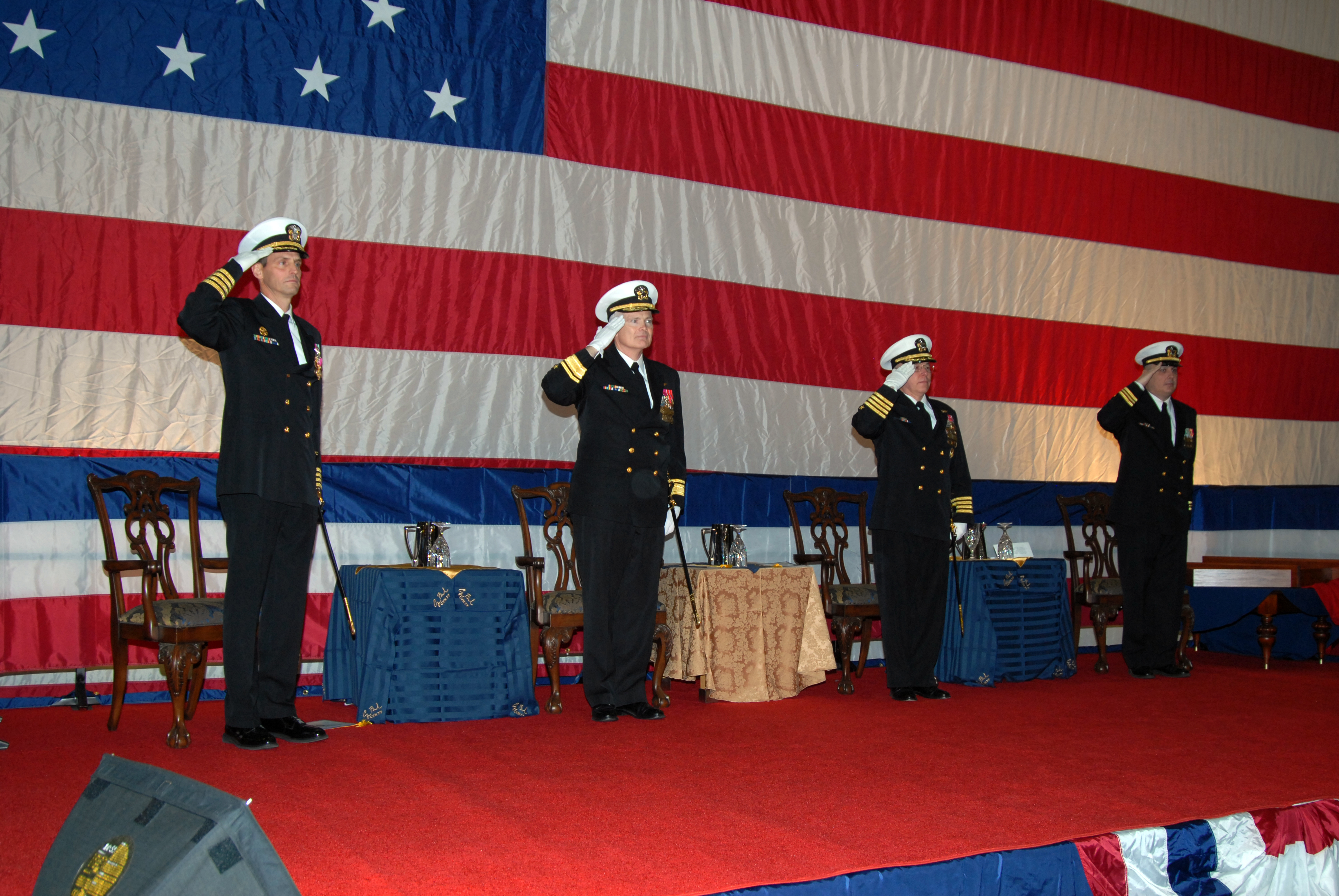 US Navy 090225-N-7656T-164 Senior officers render salutes as the colors are retired at the conclusion of the change of command ceremony aboard George H.W. Bush