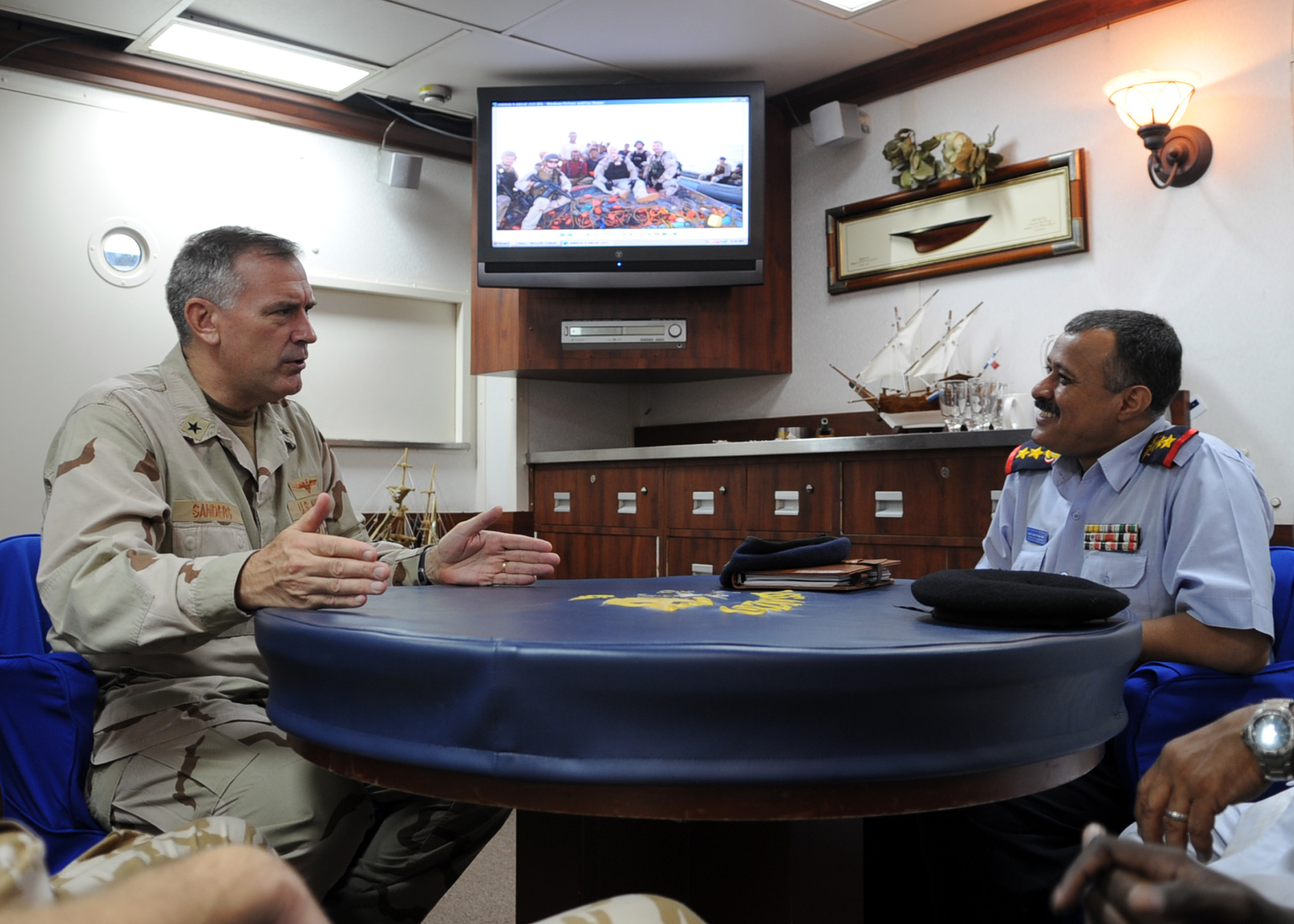 US Navy 090912-N-6814F-089 Rear Adm. Scott E. Sanders speaks with Col. Lofta Al Barati during a visit aboard the guided-missile cruiser USS Anzio (CG 68)