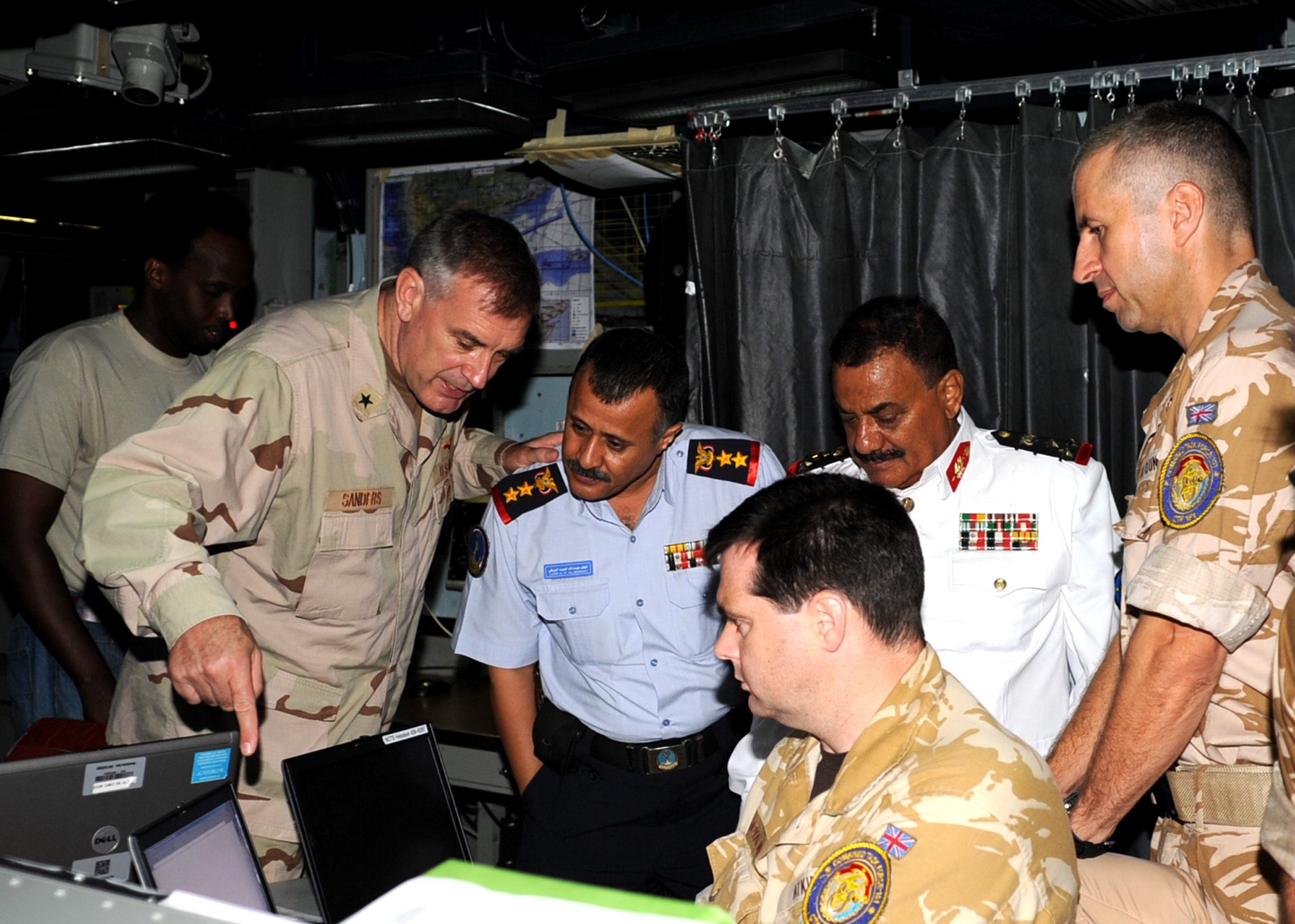 US Navy 090912-N-6814F-147 Rear Adm. Scott E. Sanders explains equipment to Col. Lofta Al Barati and Brig. Gen. Shamshan Radhan during a visit aboard the guided-missile cruiser USS Anzio (CG 68)
