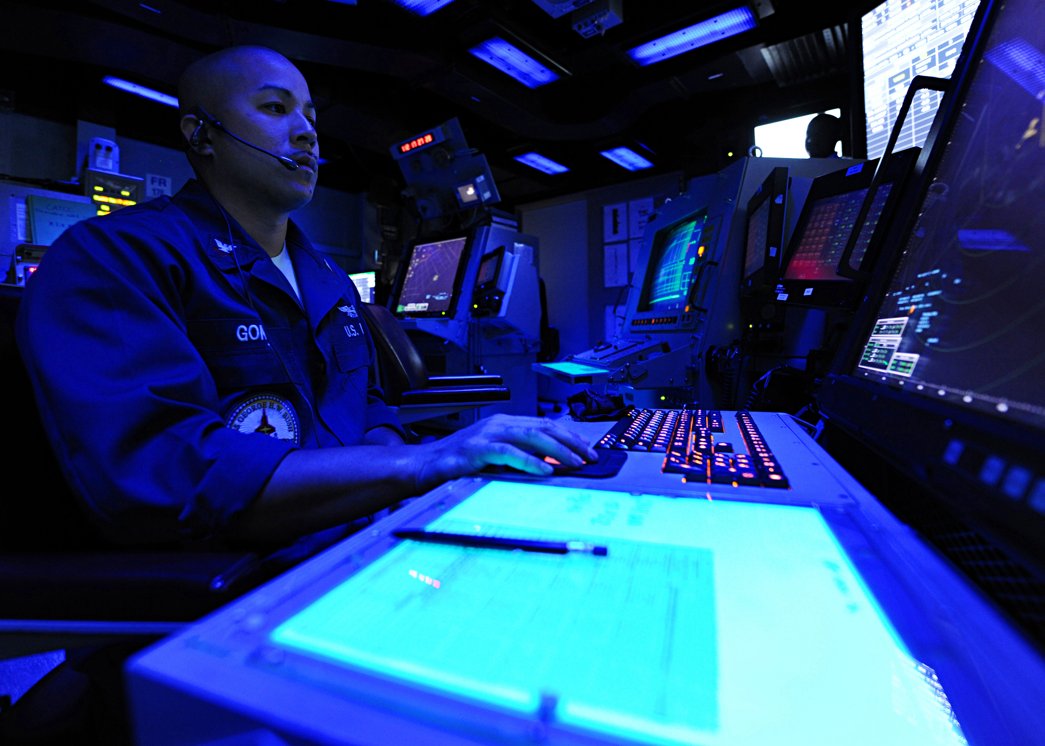 US Navy 100422-N-3885H-020 Air Traffic Controller 2nd Class Bruce Gomez stands watch in the Carrier Air Traffic Control Center aboard the aircraft carrier USS George H.W. Bush (CVN 77)