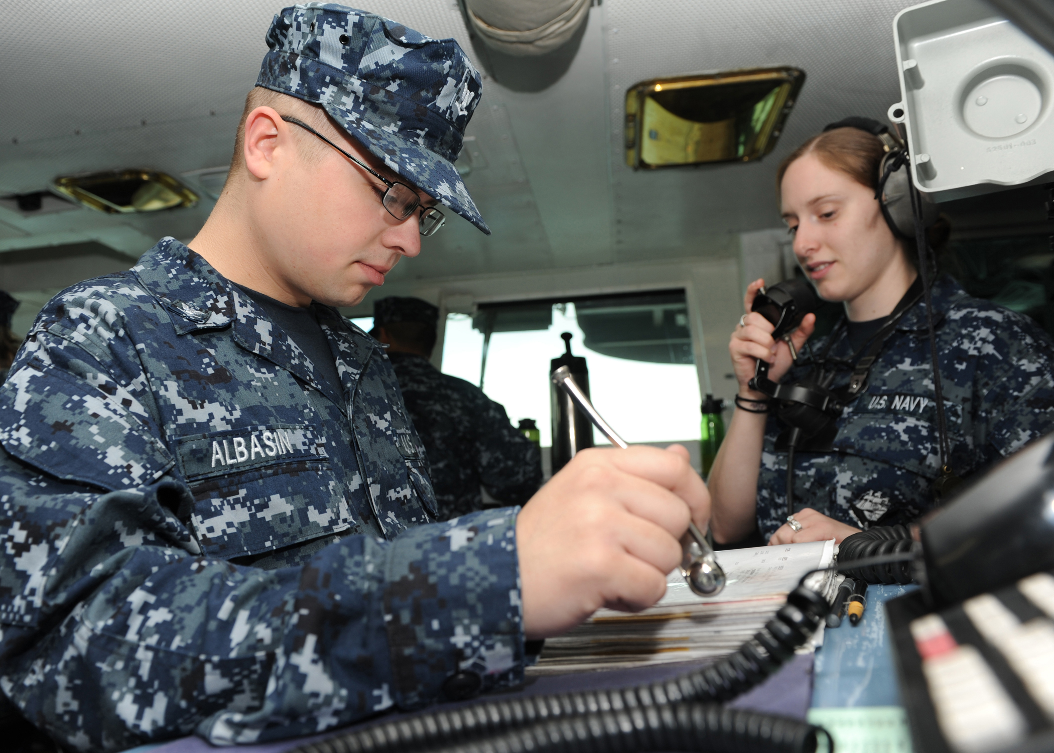 US Navy 100907-N-4997L-031 Boatswain's Mate 3rd Class Jacob Albasin, from Newark, Oh., looks through the logbook while standing watch aboard the br