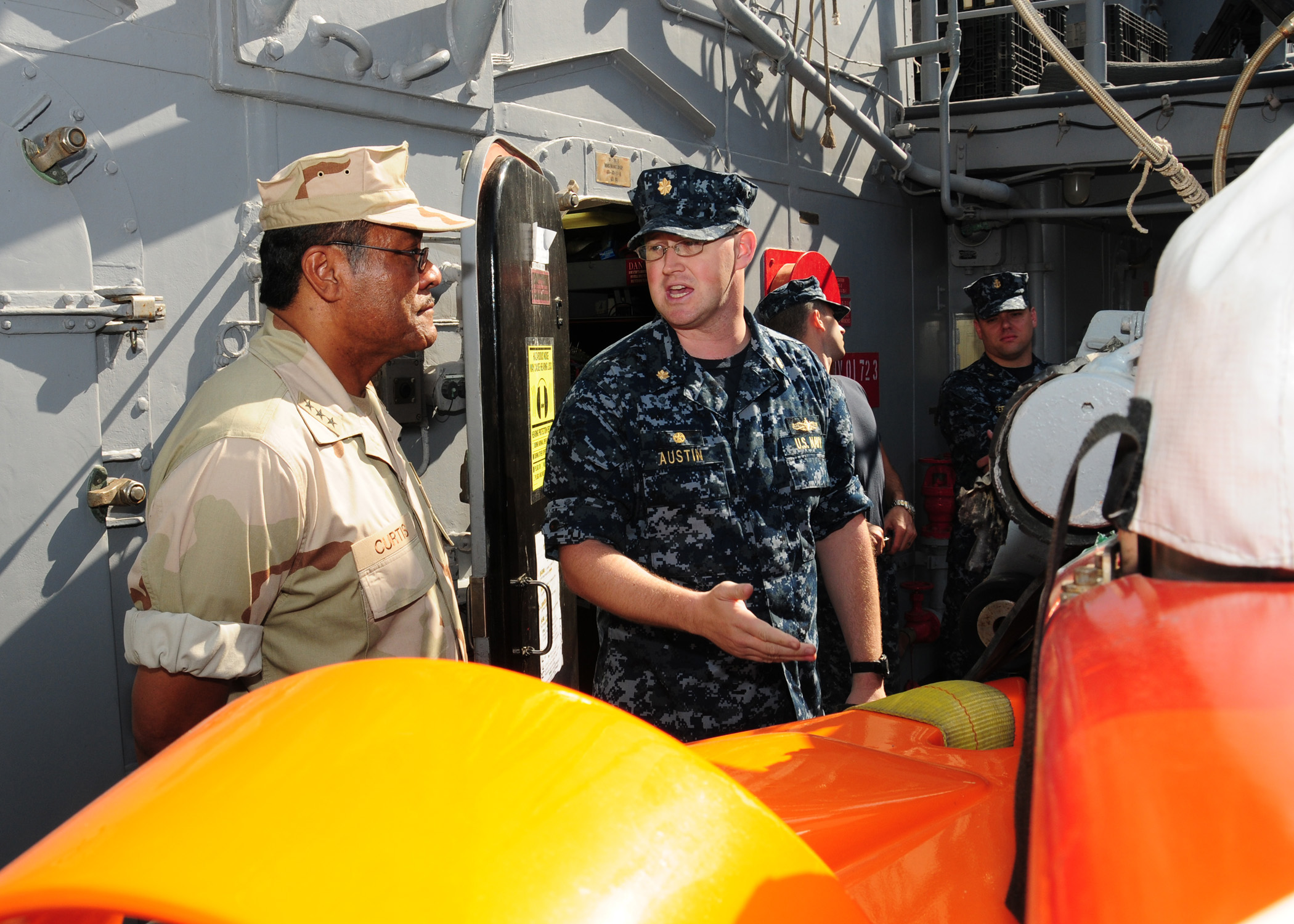 US Navy 101029-N-2903B-003 Lt. Cmdr. Spencer Austin explains the capabilities of an SLQ-48 Mine Neutralization Vehicle to Vice Adm. D.C. Curtis