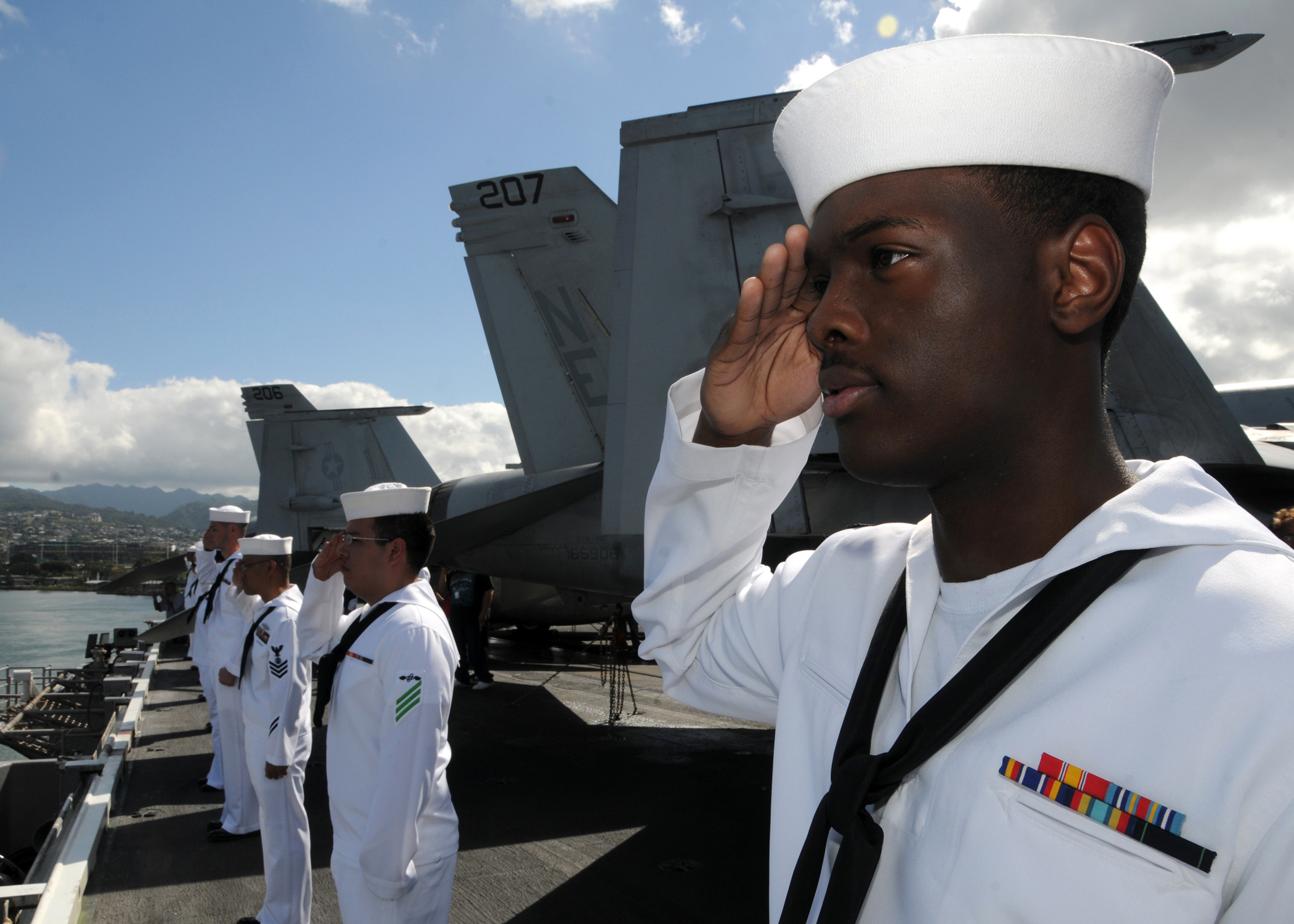 US Navy 110314-N-CQ682-047 Sailors assigned to the aircraft carrier USS Abraham Lincoln (CVN 72) render honors as the ship passes the USS Arizona M