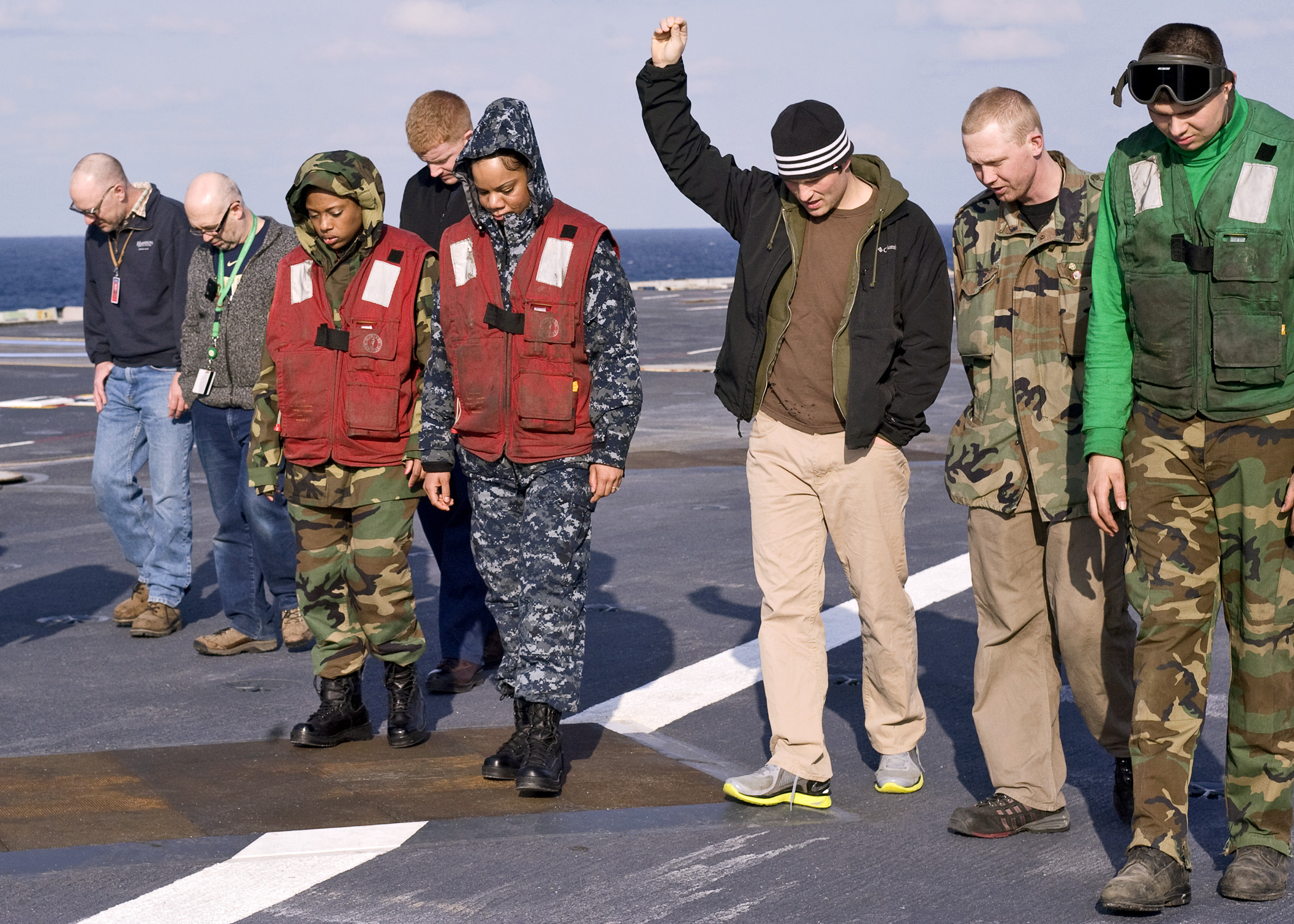 US Navy 110326-N-9626Y-015 Sailors and civilian shipyard workers conduct a foreign object debris walk down after a vertical replenishment at sea ab