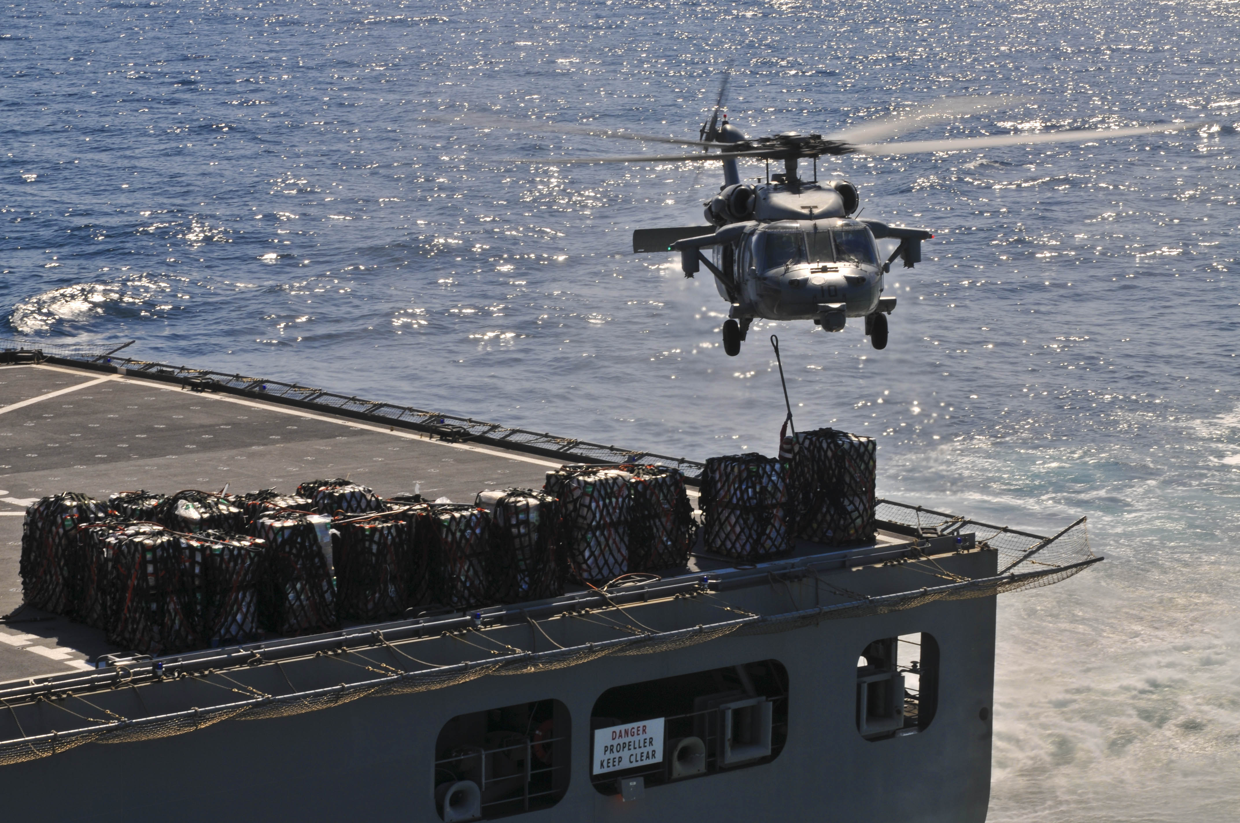 US Navy 110403-N-9950J-278 An MH-60S Sea Hawk helicopter picks up supplies from USNS Matthew Perry (T-AKE 9) during a vertical replenishment