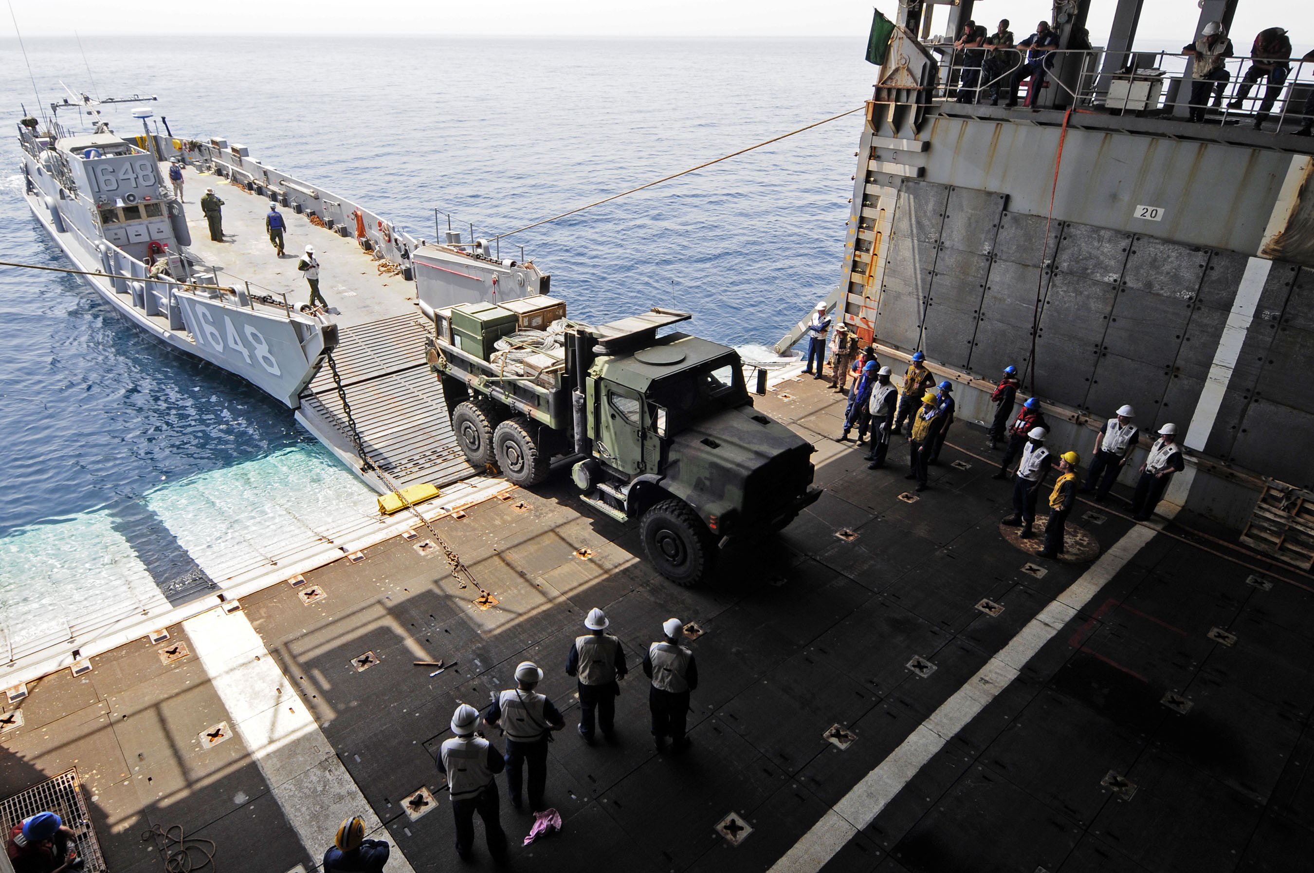 US Navy 110601-N-RC734-172 A U.S. Marine Corps 7-ton truck enters the well deck aboard USS Comstock (LSD 45) during stern gate marriage operations 
