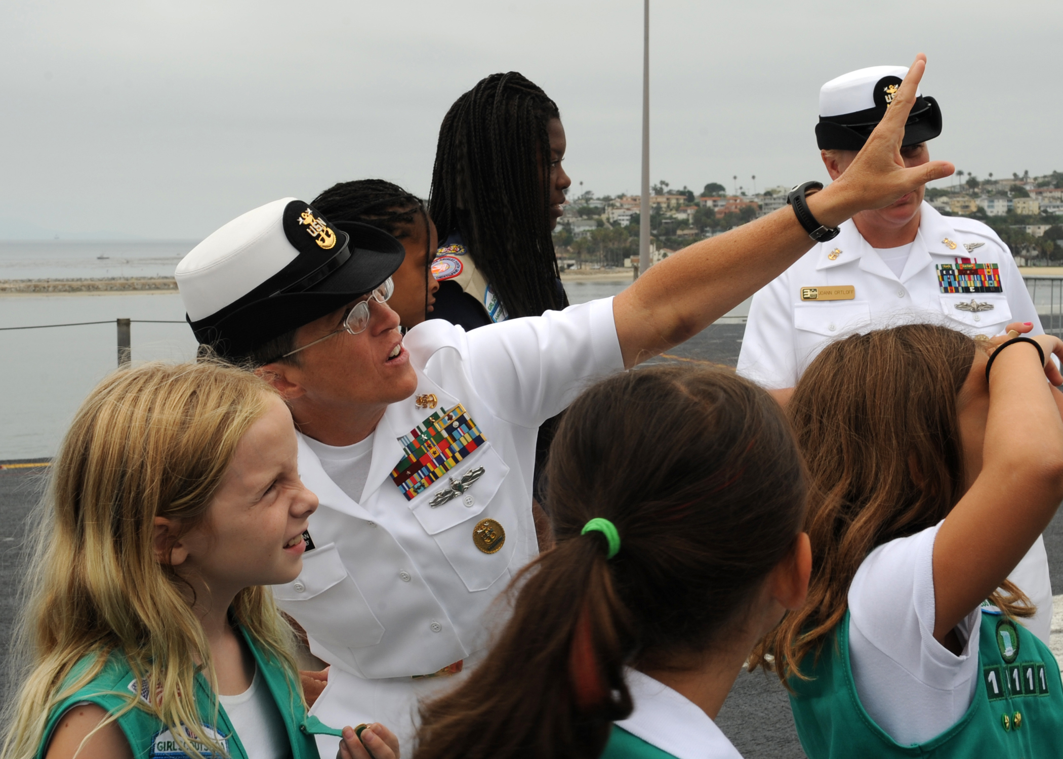 US Navy 110728-N-DO220-017 Command Master Chief Susan Whitman speaks with the Girls Scout Troop 1111 about the ship's aircrafts during a tour aboar