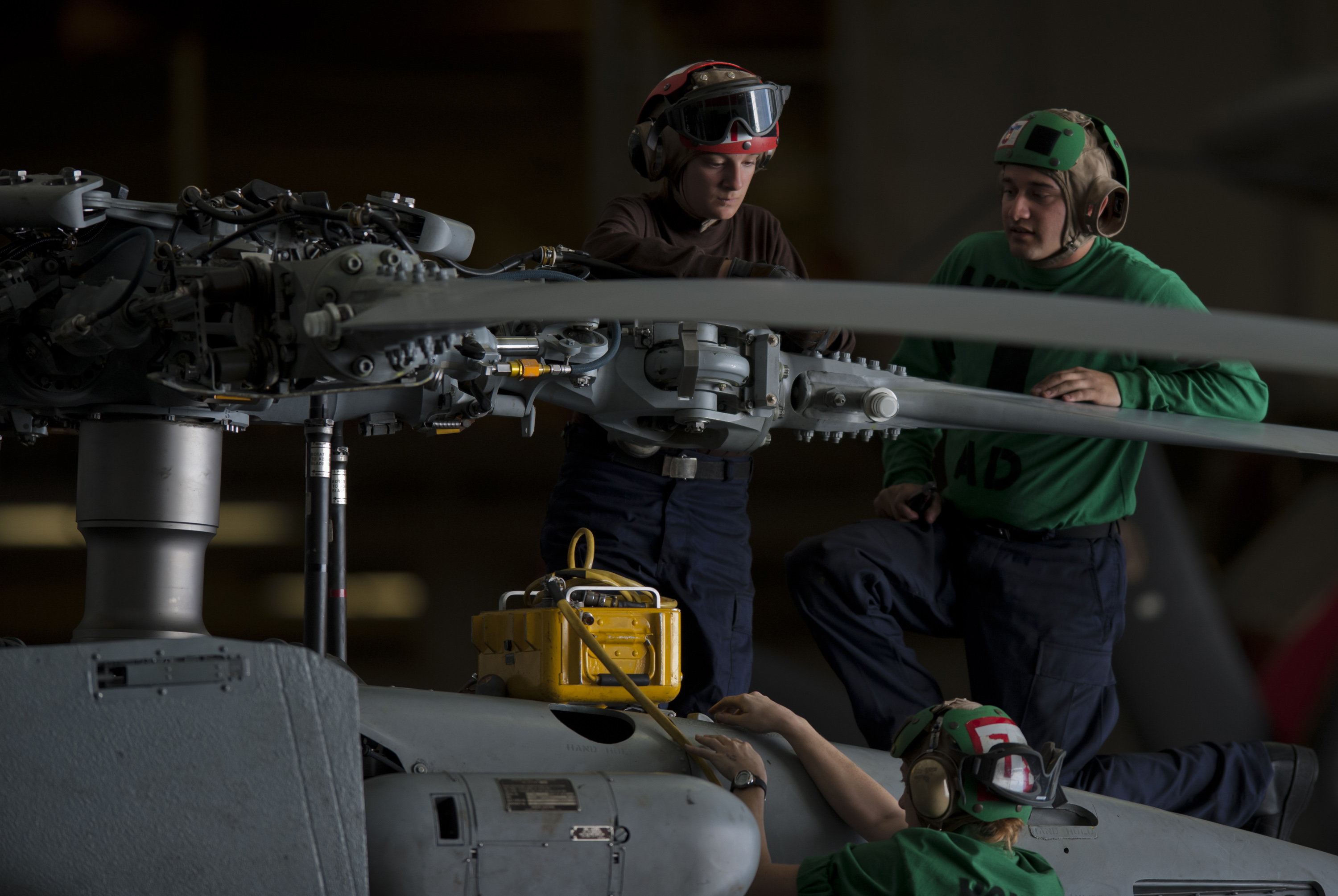 US Navy 111005-N-TU221-008 Sailors assigned to the Saberhawks of Helicopter Maritime Strike Squadron (HSM) 77 perform maintenance on the propellers