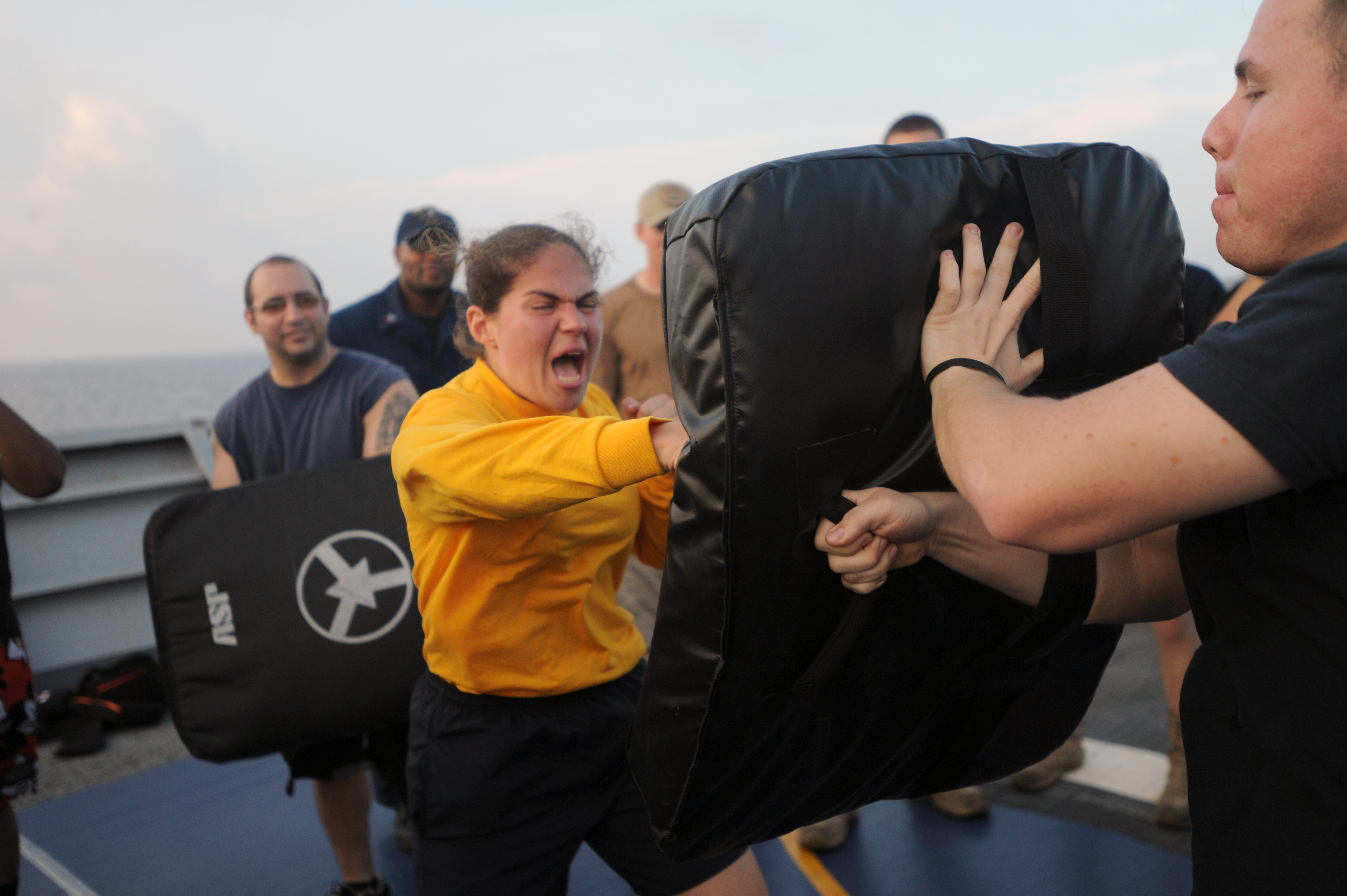 US Navy 111106-N-AX571-374 Ensign Arielle Holland hits the striking bag after being sprayed with oleoresin capsicum during security reaction force 