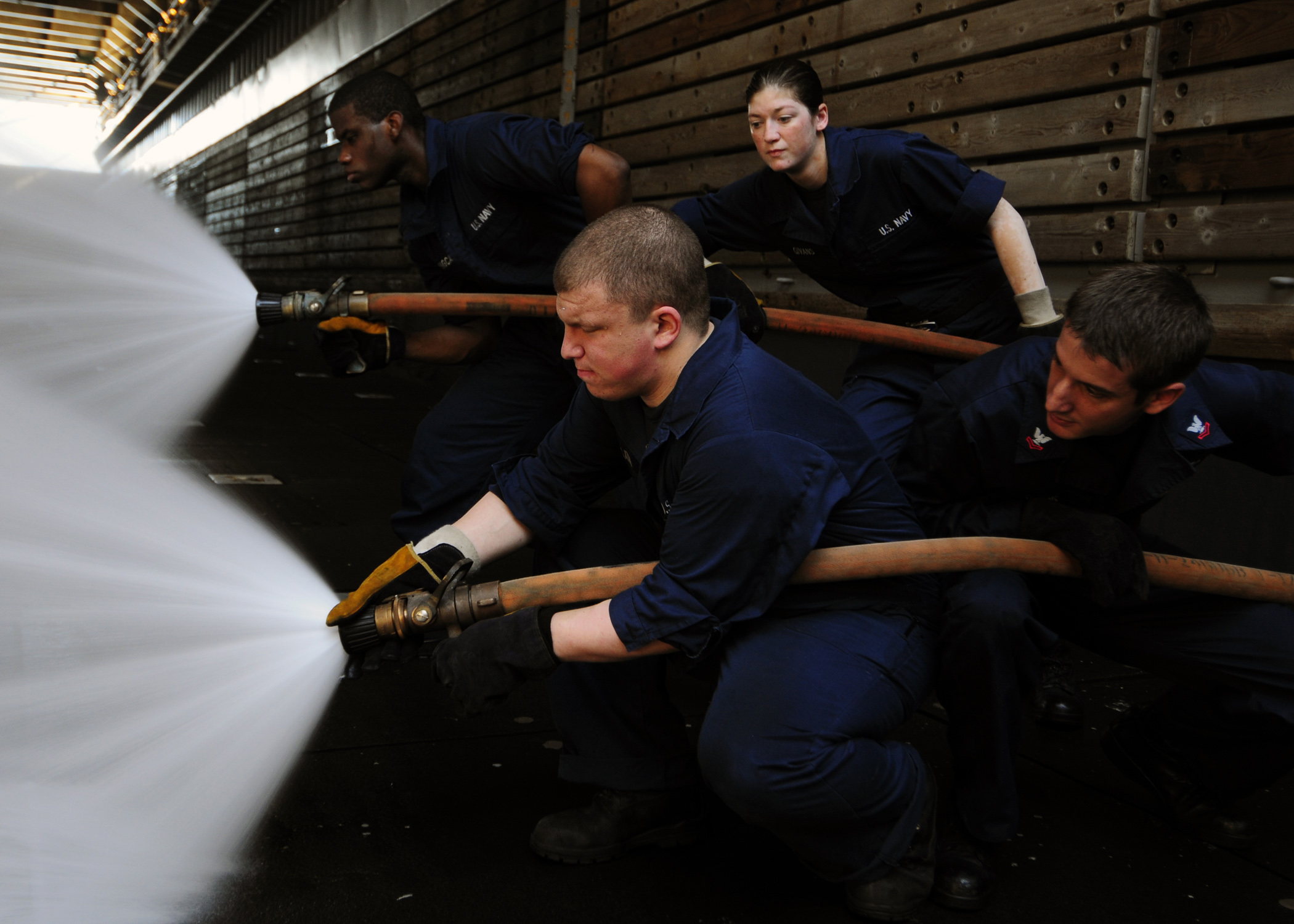 US Navy 111121-N-WJ771-146 Sailors man a fire hose during a crash and salvage drill