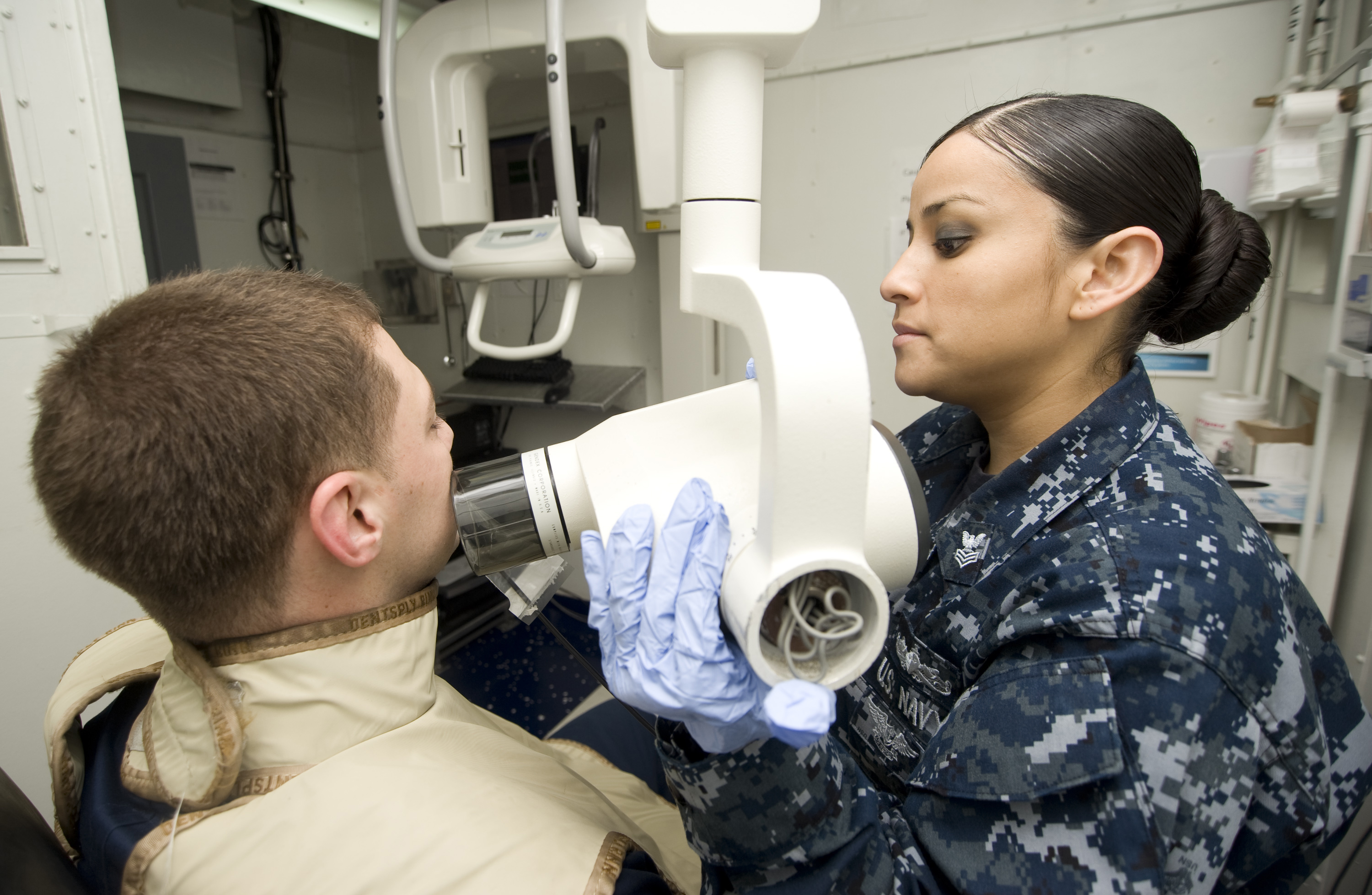 US Navy 120131-N-JN664-014 Hospital Corpsman 1st Class Laura Blanco takes X-rays of Electrician's Mate 1st Class Cory Hartley aboard the Nimitz-cla