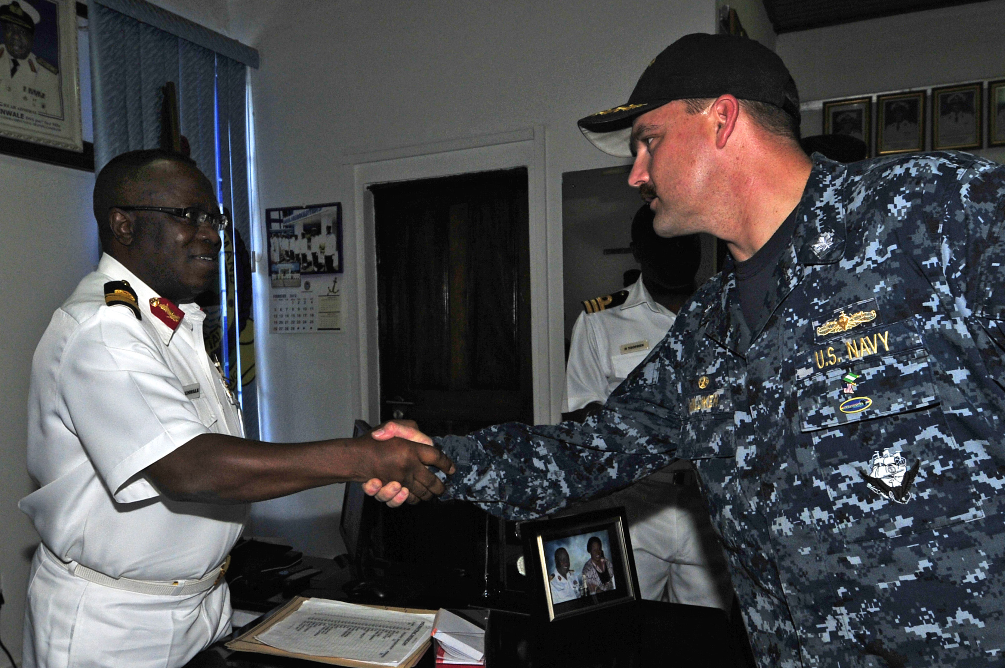US Navy 120215-N-IZ292-001 Cmdr. Leonard Milliken, commanding officer of the guided-missile frigate USS Simpson (FFG 56), greets Nigerian navy Rear