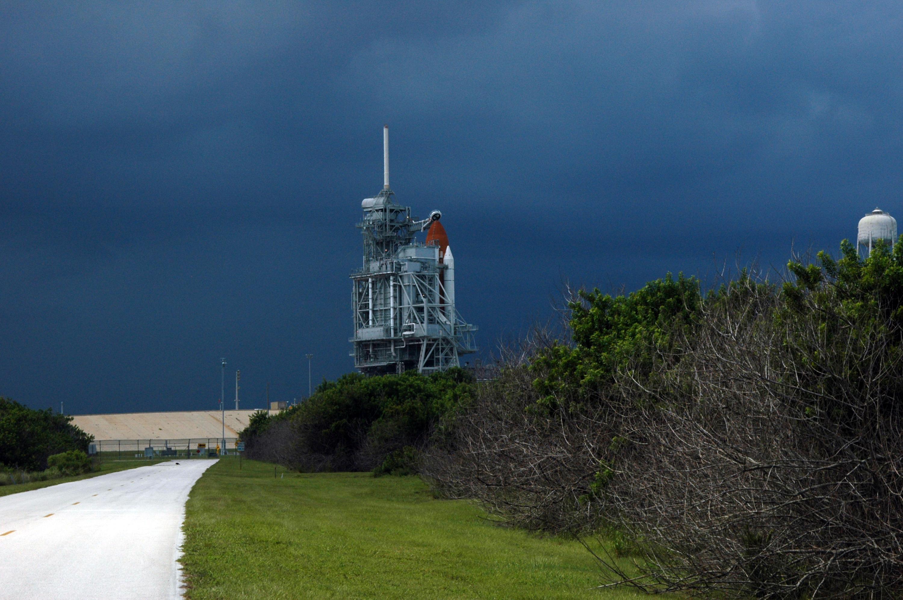 Dark clouds of an heavy rainstorm behind Space Shuttle Atlantis