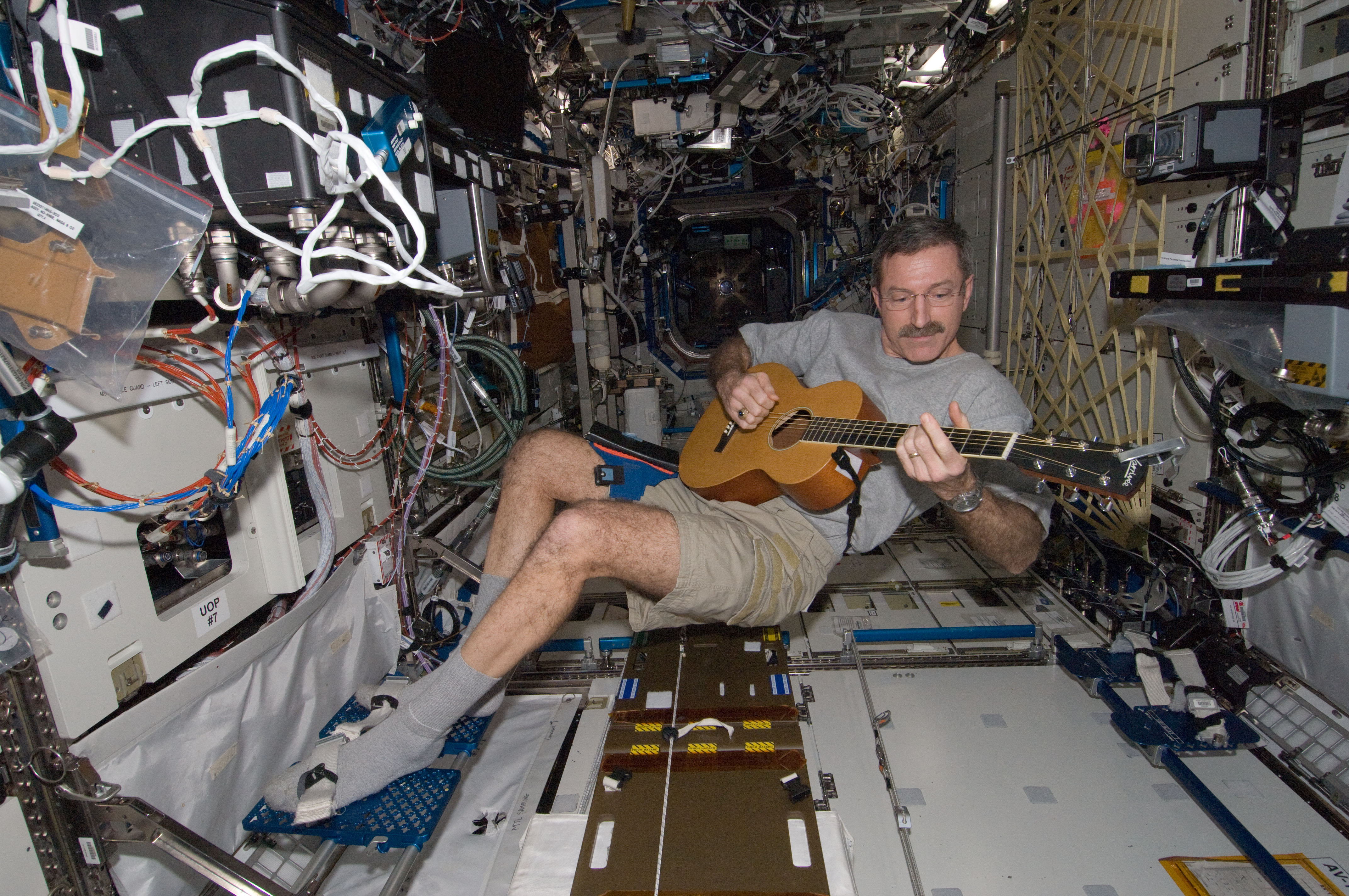 ISS-30 Dan Burbank plays a guitar in the Destiny lab