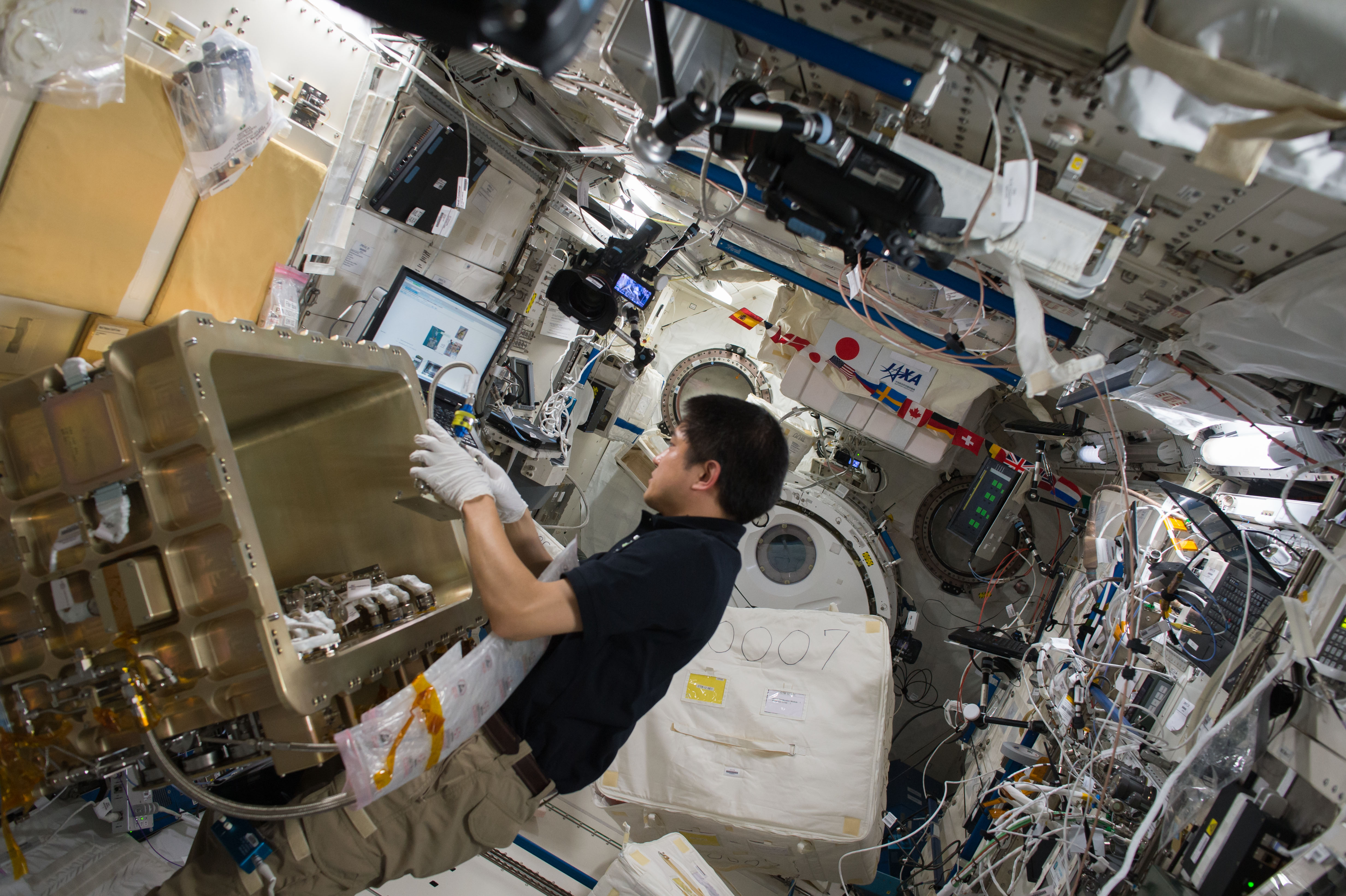ISS-49 Takuya Onishi with the Group Combustion Module in the Kibo lab
