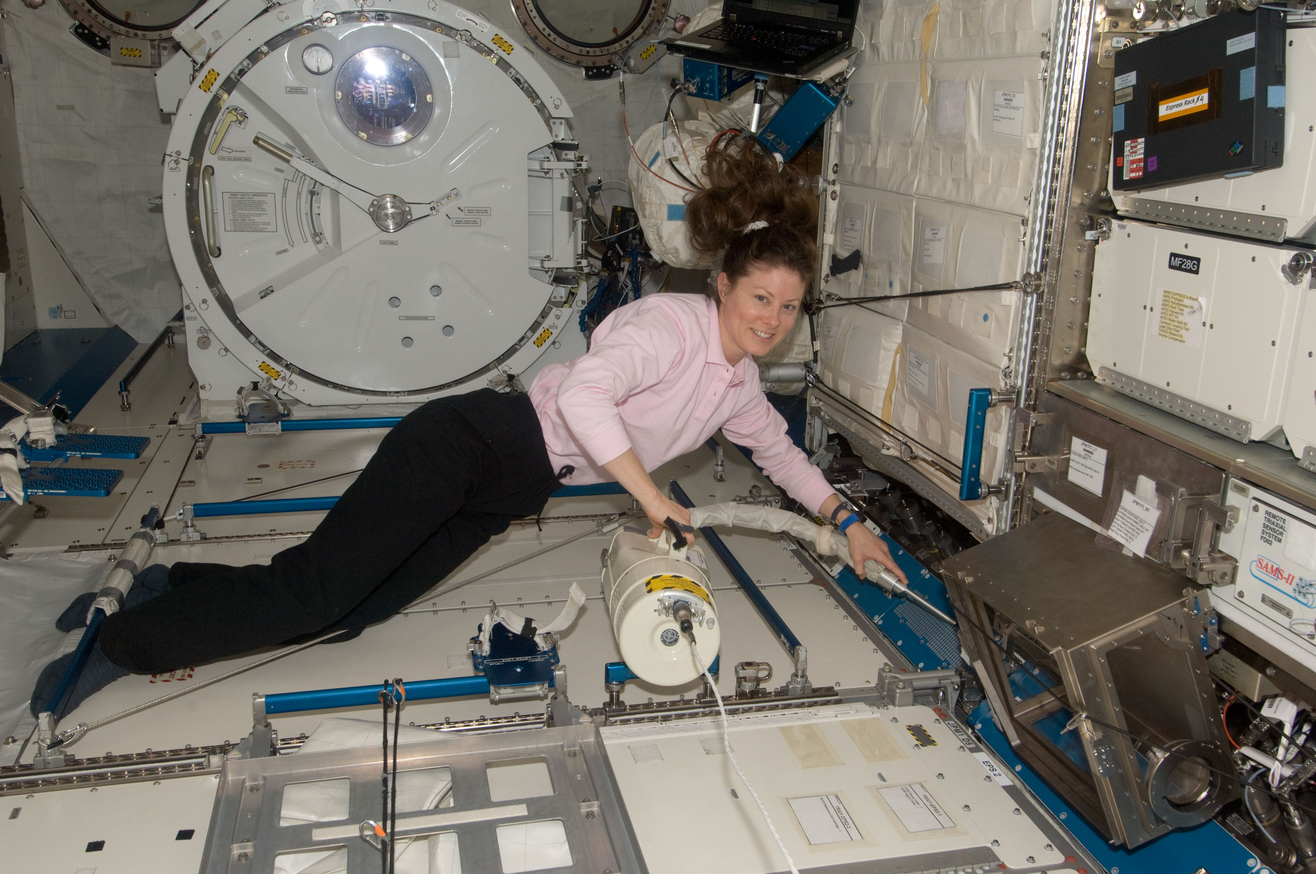 ISS-24 Tracy Caldwell Dyson during housekeeping
