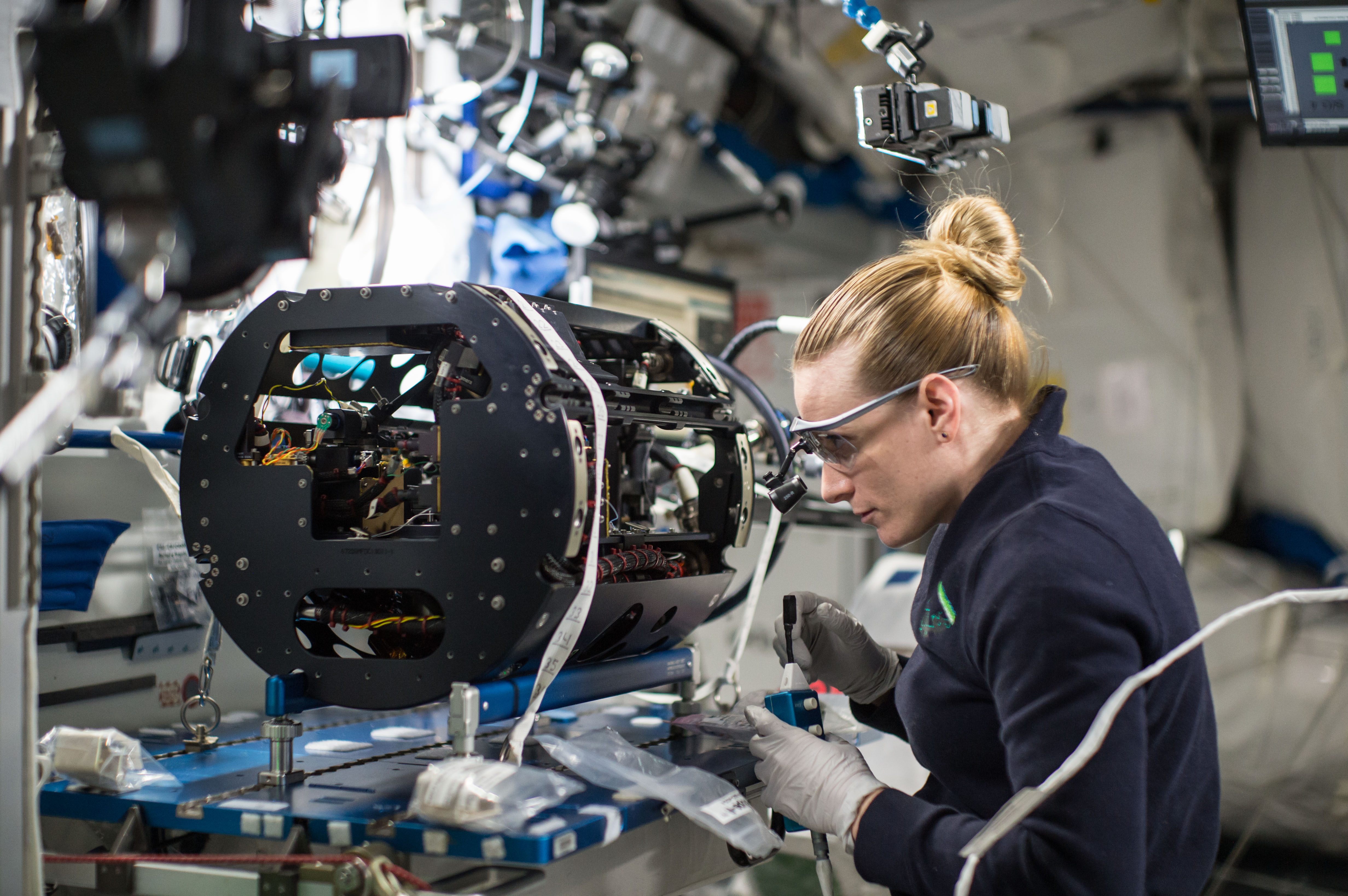 ISS-49 Kate Rubins works with the Multi-user Droplet Combustion Apparatus