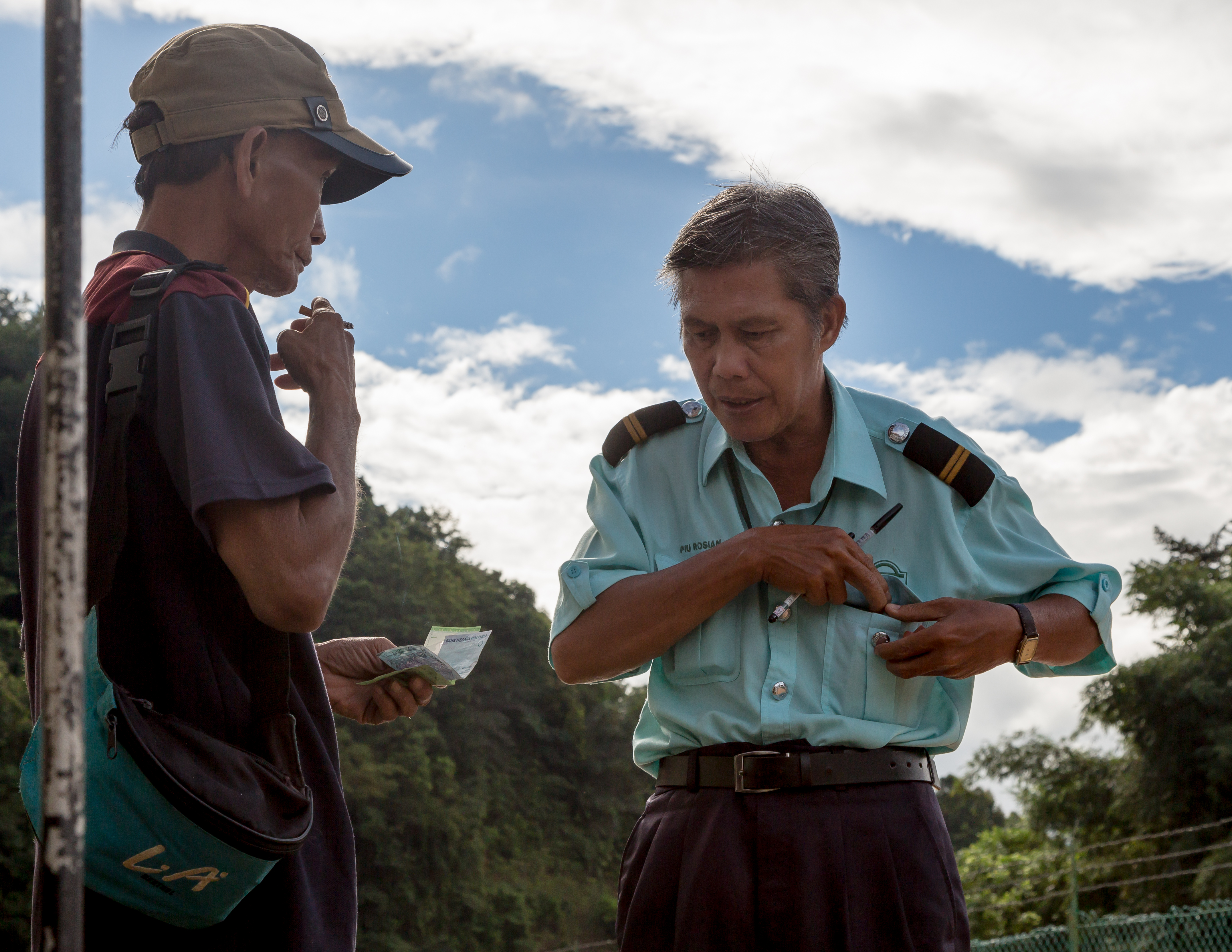 Sabah State Railway Train-Attendant-selling-a-ticket-01